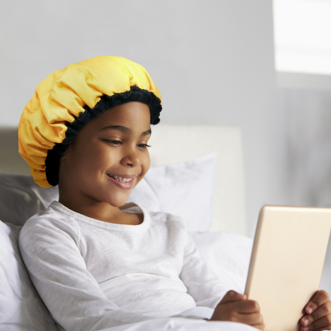 Girl wearing yellow Amber Pop Lava Cap MINI | Product option is Hot Conditioning Steamer Cap Kit for Kids + Flexi Detangler